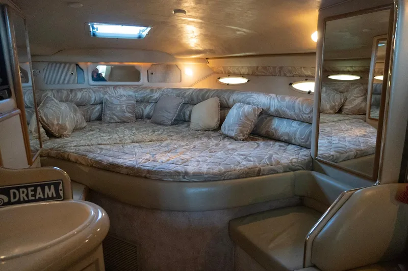 Slide: The Image of Interior of 1998 Sea Ray Sundancer 330, featuring a cozy, well-lit cabin with plush bedding. - 15