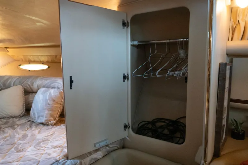 Slide: The Image of Interior of 1998 Sea Ray Sundancer 330 with open closet and bed. - 16