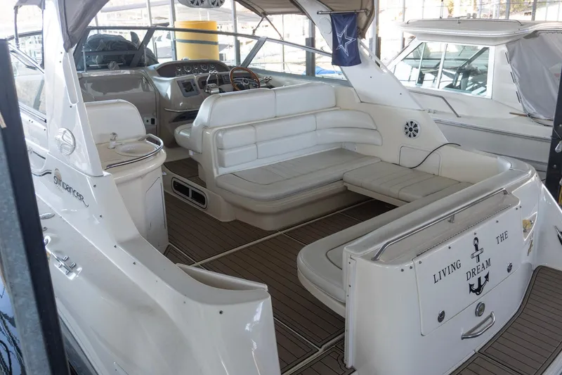 Slide: The Image of 1998 Sea Ray Sundancer 330 interior with white seating and wood flooring. - 2