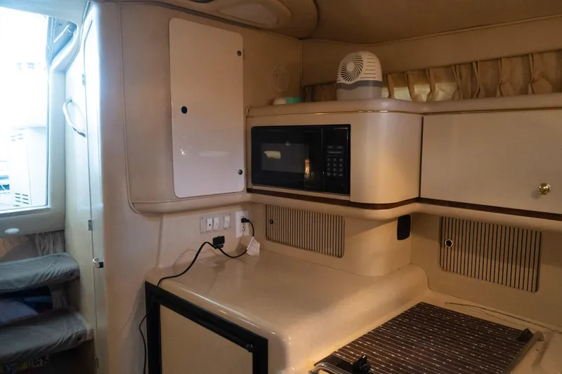 Slide: The Image of Interior of 1998 Sea Ray Sundancer 330 with microwave and compact kitchen area. - 20