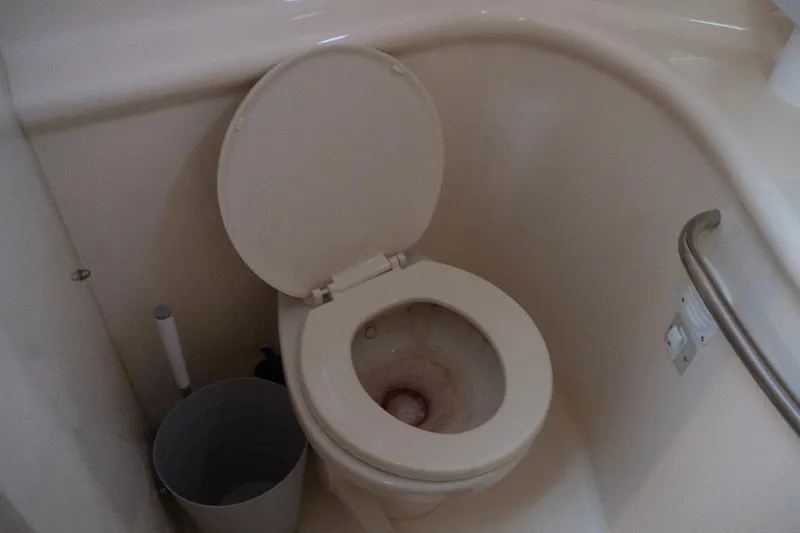 Slide: The Image of Toilet in 1998 Sea Ray Sundancer 330 boat bathroom with grab bar and bucket. - 25