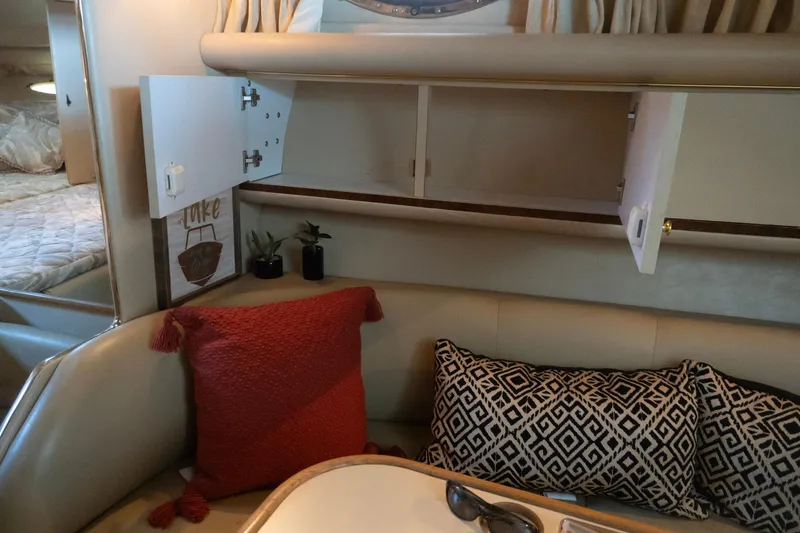Slide: The Image of Interior of 1998 Sea Ray Sundancer 330 with cozy seating and decorative pillows. - 29