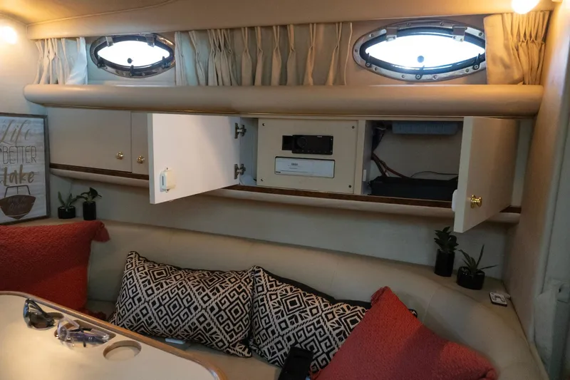 Slide: The Image of Interior of 1998 Sea Ray Sundancer 330 with open cabinets and decorative pillows. - 30