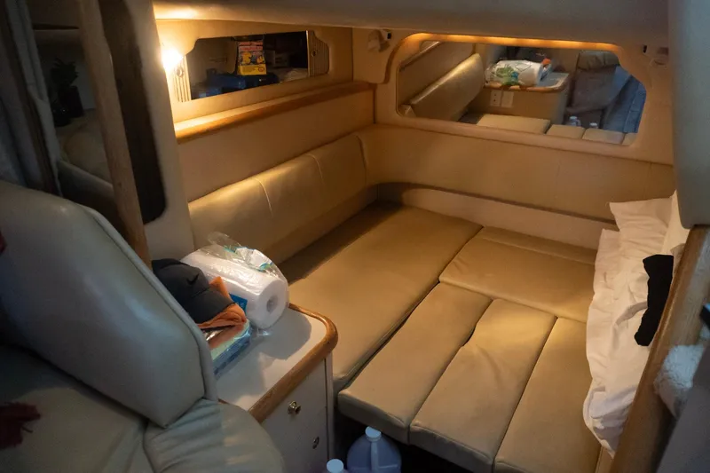 Slide: The Image of 1998 Sea Ray Sundancer 330 cabin interior with beige seating and cozy lighting. - 32