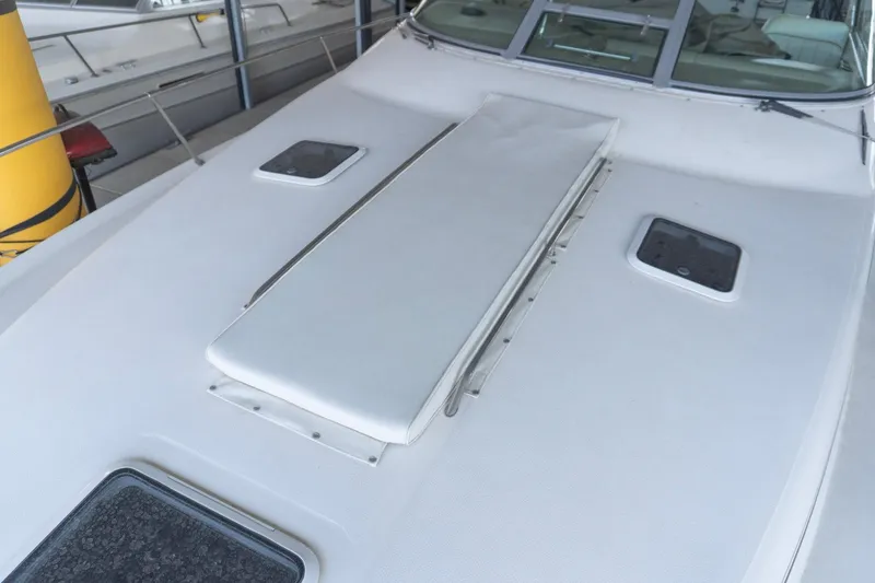 Slide: The Image of 1998 Sea Ray Sundancer 330 boat deck with hatches and sunpad. - 34