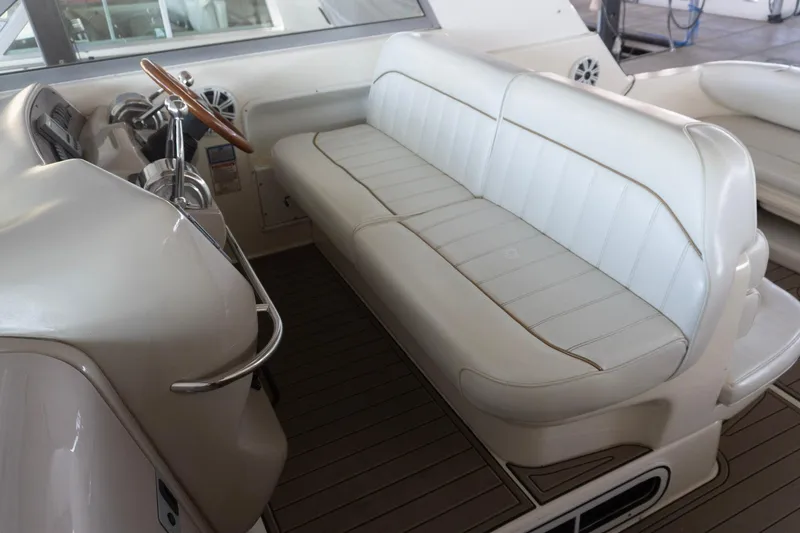 Slide: The Image of 1998 Sea Ray Sundancer 330 helm with white leather seating and wooden steering wheel. - 5
