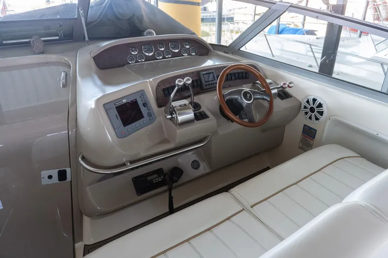 Slide: The Image of 1998 Sea Ray Sundancer 330 helm with steering wheel, controls, and navigation equipment. - 6