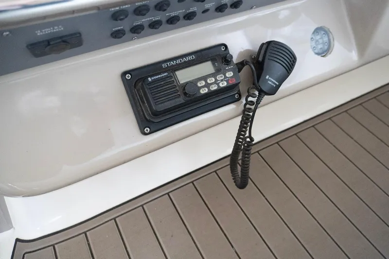 Slide: The Image of 1998 Sea Ray Sundancer 330 boat dashboard with radio and microphone. - 7