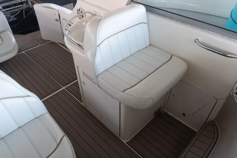 Slide: The Image of 1998 Sea Ray Sundancer 330 interior with white seating and wood-patterned flooring. - 8