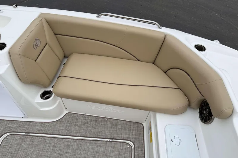 Slide: The Image of 2020 NauticStar 203 SC boat with beige cushioned seating and cup holders. - 11