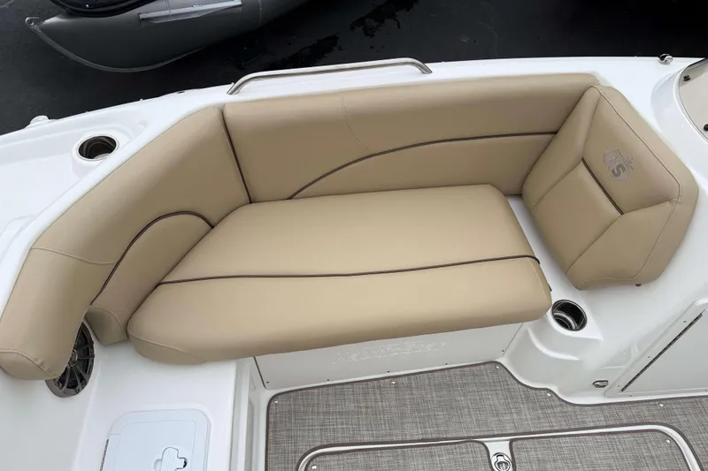 Slide: The Image of 2020 NauticStar 203 SC boat with beige cushioned seating and integrated cup holders. - 12