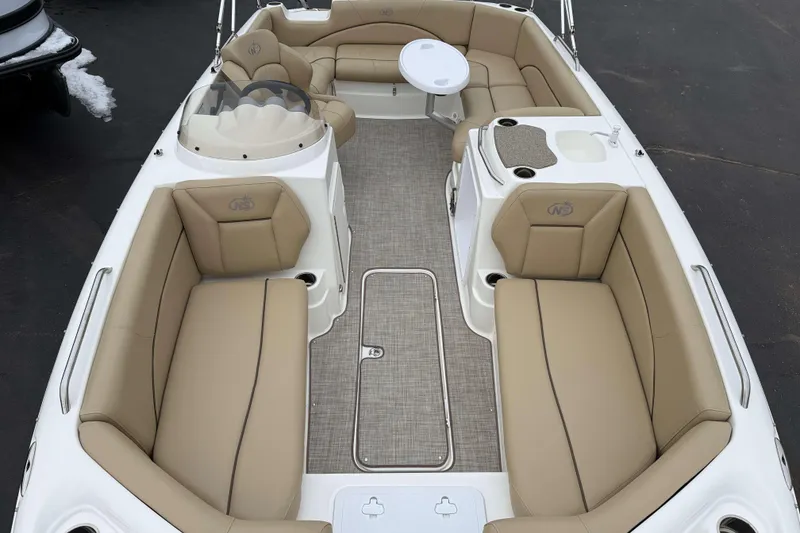 Slide: The Image of 2020 NauticStar 203 SC boat interior with beige seating and table. - 13