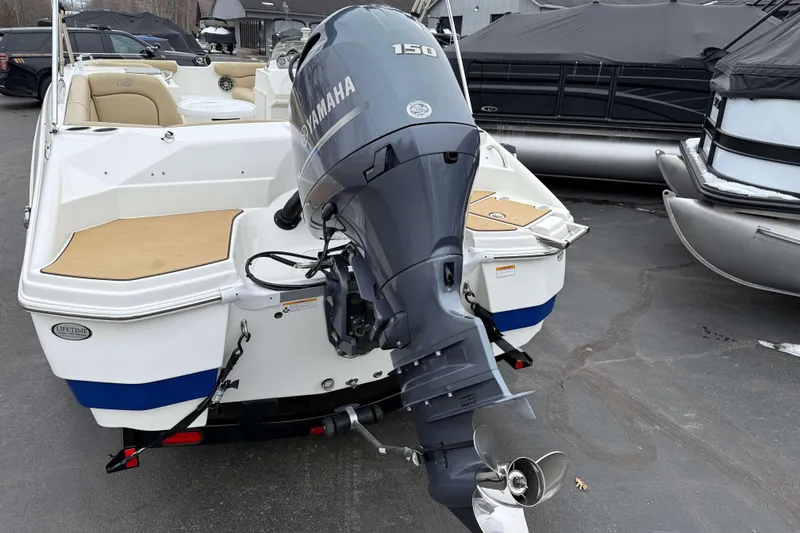 Slide: The Image of 2020 NauticStar 203 SC boat with Yamaha 150 outboard motor, docked in a marina. - 17