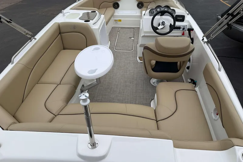 Slide: The Image of 2020 NauticStar 203 SC boat interior with beige seating and steering console. - 4