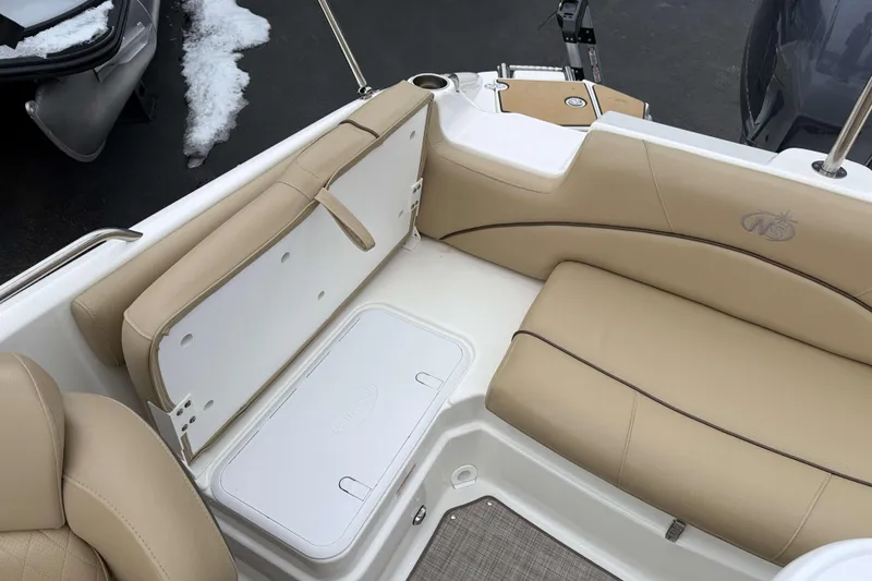 Slide: The Image of 2020 NauticStar 203 SC boat interior with beige seating and storage compartment. - 8