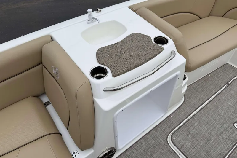 Slide: The Image of 2020 NauticStar 203 SC boat interior with beige seating and built-in sink. - 9