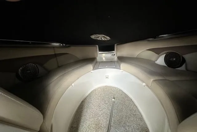 Slide: The Image of Interior of 2007 Chaparral Sunesta 254 boat, featuring cushioned seating and carpeted flooring. - 11