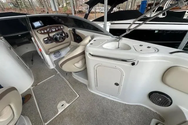 Slide: The Image of 2007 Chaparral Sunesta 254 boat interior with steering wheel and sink area. - 15