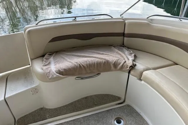 Slide: The Image of 2007 Chaparral Sunesta 254 boat interior with beige seating and towel. - 16