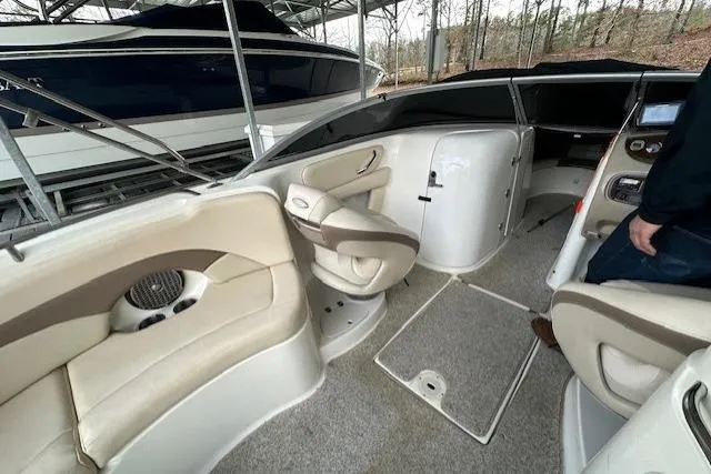 Slide: The Image of 2007 Chaparral Sunesta 254 boat interior with beige seating and control panel. - 17