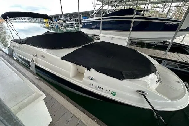 Slide: The Image of 2007 Chaparral Sunesta 254 boat docked with black covers, under marina shelter. - 5