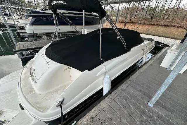 Slide: The Image of 2007 Chaparral Sunesta 254 boat docked with black cover in marina. - 6