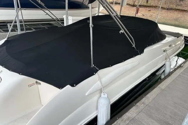Slide: The Image of 2007 Chaparral Sunesta 254 boat with black cover docked at marina. - 7