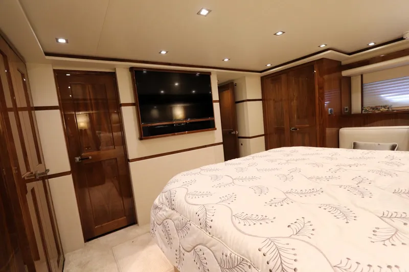 Slide: The Image of Luxurious bedroom interior of 2017 Viking 80 Enclosed Bridge yacht with elegant wood finishes. - 16
