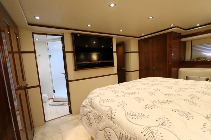 Slide: The Image of Luxurious bedroom interior of 2017 Viking 80 Enclosed Bridge yacht with elegant wood finishes. - 18