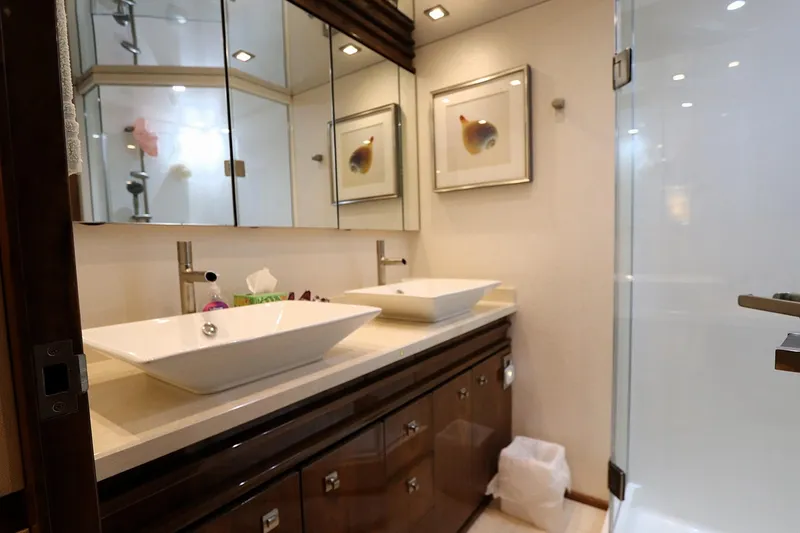 Slide: The Image of Luxurious bathroom in 2017 Viking 80 Enclosed Bridge yacht with dual sinks and modern decor. - 19