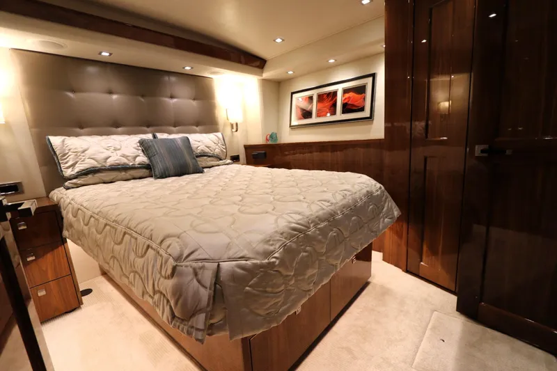 Slide: The Image of Luxurious bedroom interior of 2017 Viking 80 Enclosed Bridge yacht, featuring elegant decor. - 22