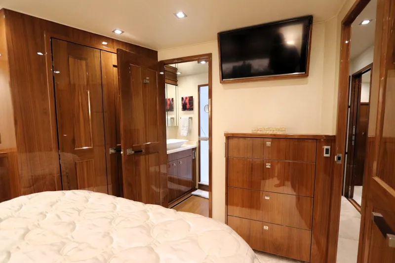 Slide: The Image of Luxurious interior of 2017 Viking 80 Enclosed Bridge yacht with wood finishes and modern amenities. - 24