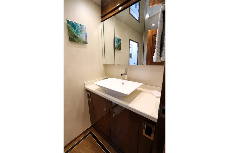 Slide: The Image of Luxurious bathroom in 2017 Viking 80 Enclosed Bridge yacht with modern sink and elegant decor. - 30