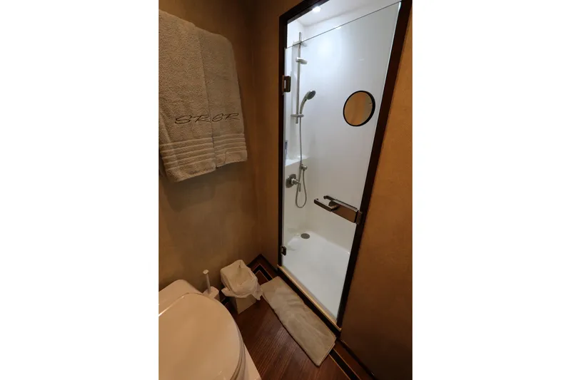 Slide: The Image of Luxurious bathroom in 2017 Viking 80 Enclosed Bridge yacht with glass shower and towel. - 31