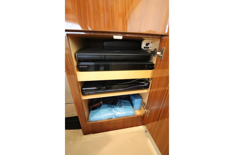 Slide: The Image of Cabinet with electronic devices on a 2017 Viking 80 Enclosed Bridge yacht. - 35