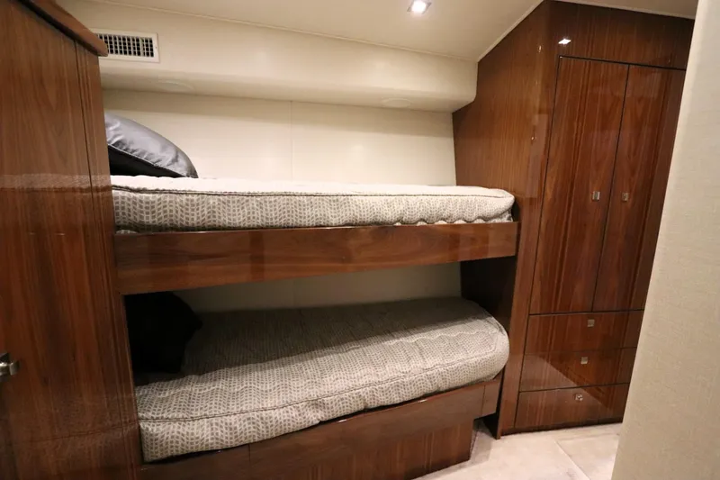 Slide: The Image of Bunk beds in 2017 Viking 80 Enclosed Bridge yacht cabin with wooden cabinetry. - 41