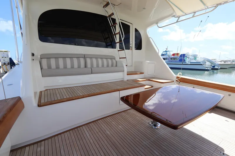 Slide: The Image of 2017 Viking 80 Enclosed Bridge yacht with sleek deck and seating area. - 44