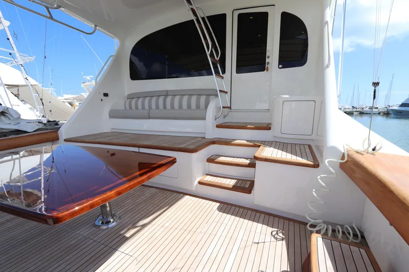 Slide: The Image of Luxurious 2017 Viking 80 Enclosed Bridge yacht interior with elegant seating and polished wood table. - 45