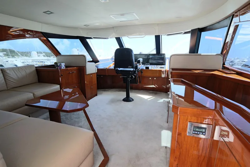 Slide: The Image of Luxurious interior of 2017 Viking 80 Enclosed Bridge yacht with plush seating and helm. - 47