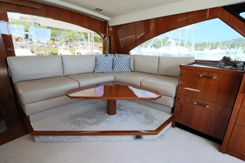 Slide: The Image of Luxurious interior of 2017 Viking 80 Enclosed Bridge yacht with elegant seating and wooden accents. - 48