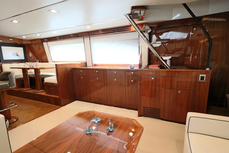 Slide: The Image of Luxurious interior of 2017 Viking 80 Enclosed Bridge yacht with elegant wood finishes. - 5