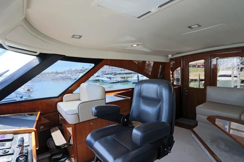 Slide: The Image of Interior of 2017 Viking 80 Enclosed Bridge yacht with luxurious seating and helm. - 52