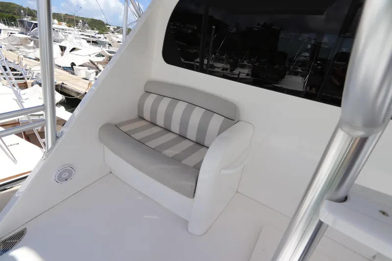 Slide: The Image of 2017 Viking 80 Enclosed Bridge yacht with striped seating on deck. - 53