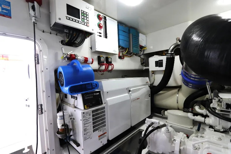 Slide: The Image of Engine room of 2017 Viking 80 Enclosed Bridge yacht with Cummins Onan generator. - 56