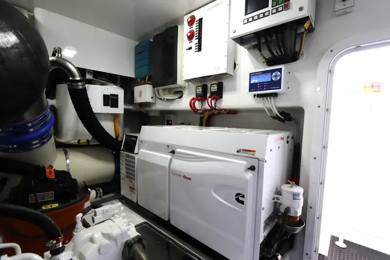 Slide: The Image of Engine room of 2017 Viking 80 Enclosed Bridge yacht with Cummins Onan generator. - 57