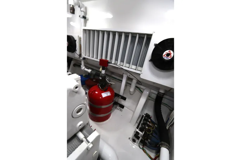 Slide: The Image of Engine room of 2017 Viking 80 Enclosed Bridge yacht with fire extinguisher and ventilation system. - 58