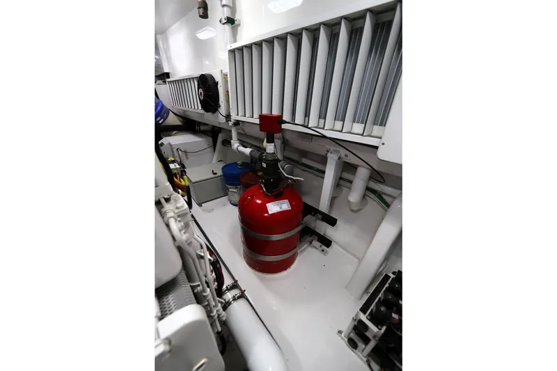 Slide: The Image of Engine room of 2017 Viking 80 Enclosed Bridge yacht with fire extinguisher and equipment. - 59