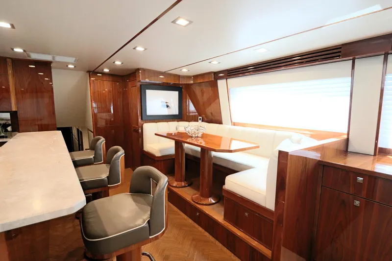 Slide: The Image of Luxurious interior of 2017 Viking 80 Enclosed Bridge yacht with elegant seating and dining area. - 6