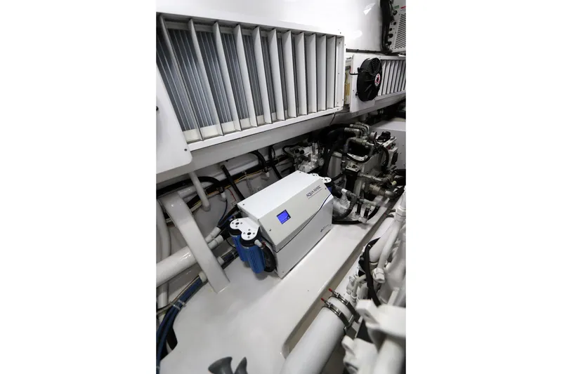 Slide: The Image of Engine room of 2017 Viking 80 Enclosed Bridge yacht, featuring advanced machinery and equipment. - 60