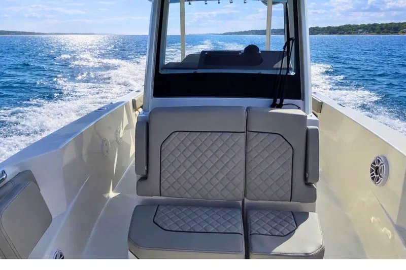 Slide: The Image of 2025 Pursuit S 288 Sport boat cruising on open water, featuring comfortable seating. - 12